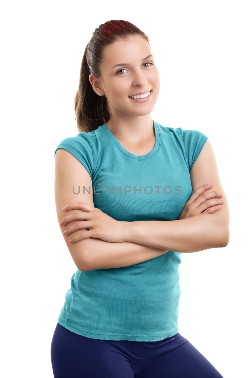 Pretty fit girl or fitness instructor posing and smiling, standing with folded arms looking at camera, isolated on white background.