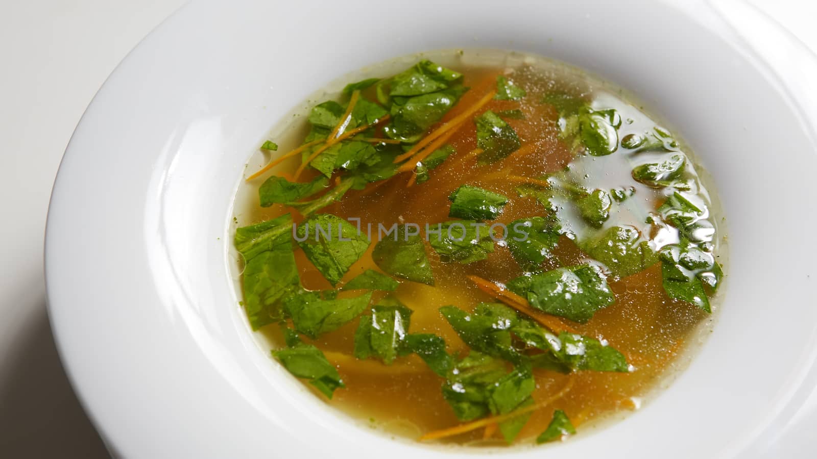 Hot broth with ravioli and green onions. Studio Photo. by sarymsakov