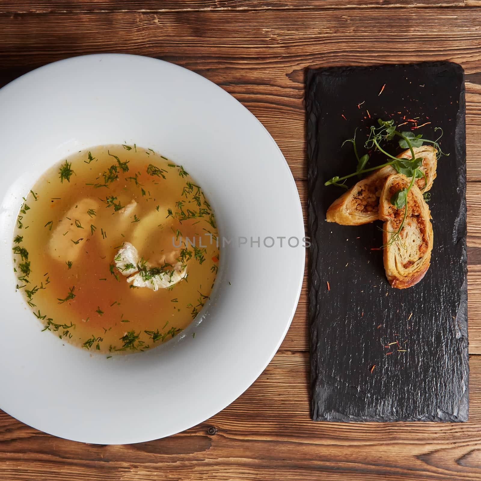 Beautiful presentation of the fish soup in a white plate, with b by sarymsakov