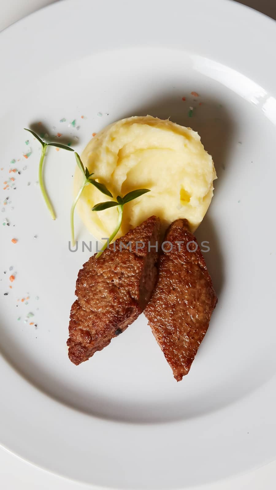 delicious mashed potatoes sprinkled with greens, juicy meat cutl by sarymsakov