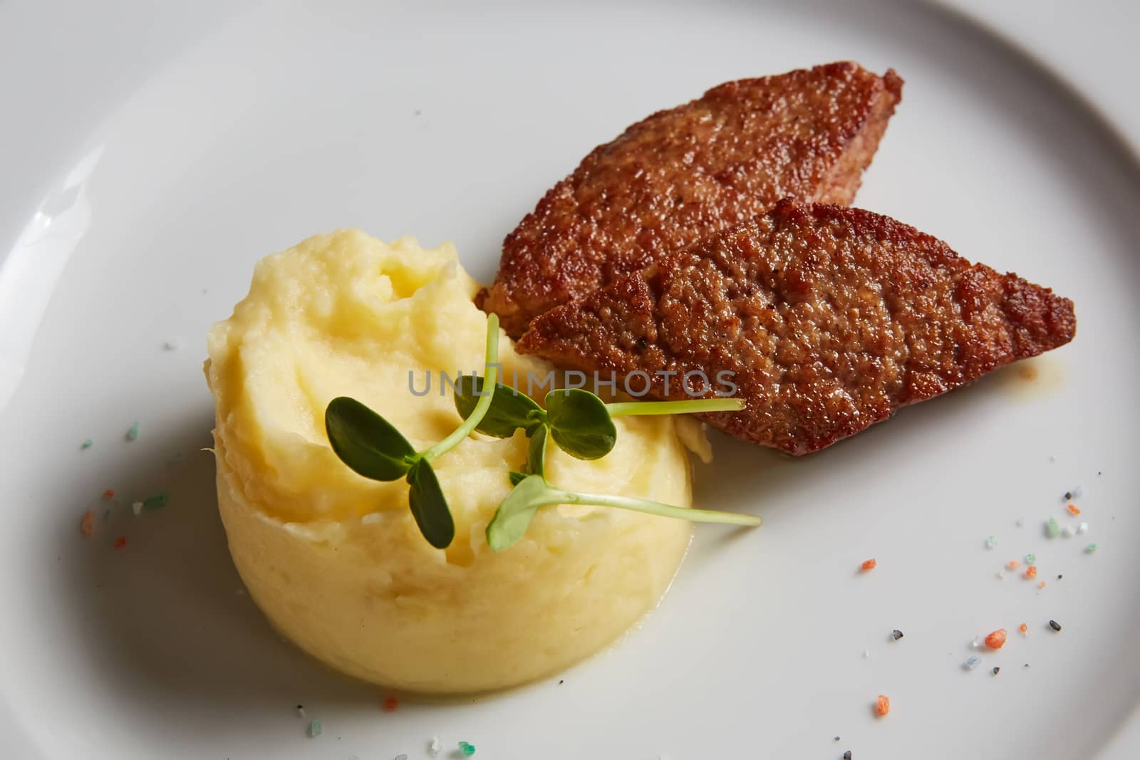 delicious mashed potatoes sprinkled with greens, juicy meat cutl by sarymsakov