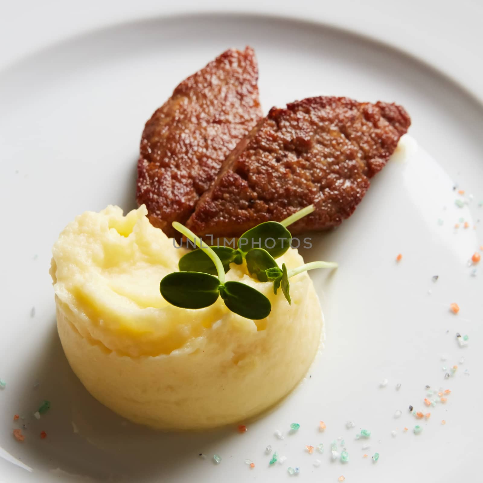 delicious mashed potatoes sprinkled with greens, juicy meat cutlets.