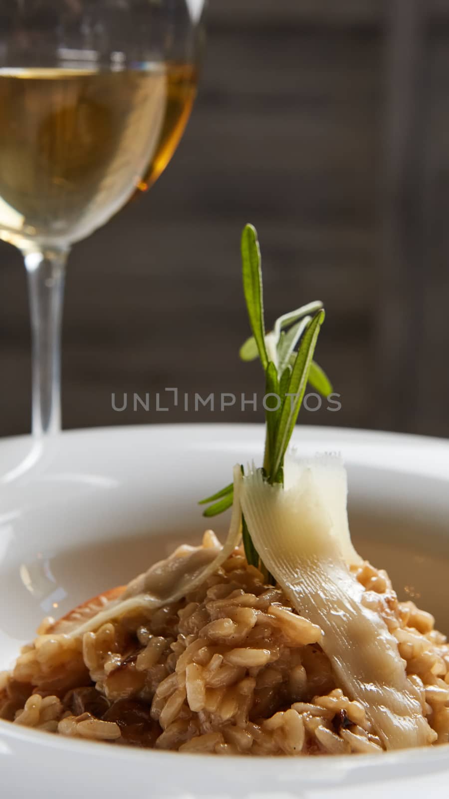 Italian dish risotto with wild white mushrooms and Parmesan cheese in a white plate