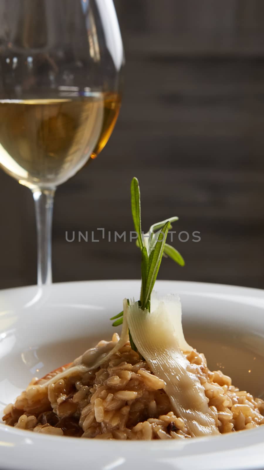 Italian dish risotto with wild white mushrooms and Parmesan cheese in a white plate