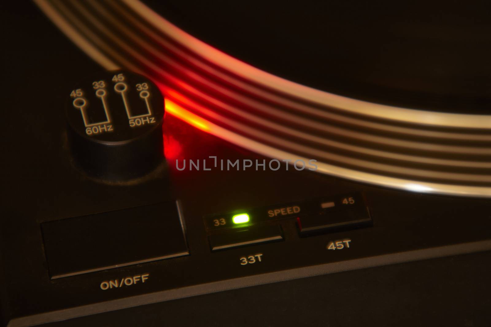 Switches on and off and rotation speed of an old turntable for vintage DJ.