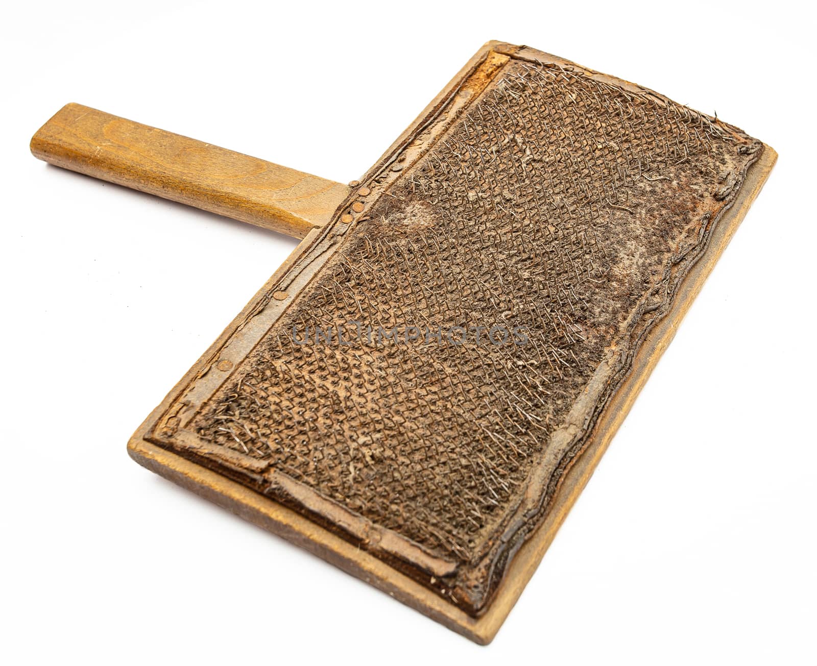 isolated wood wool carding comb against a white background