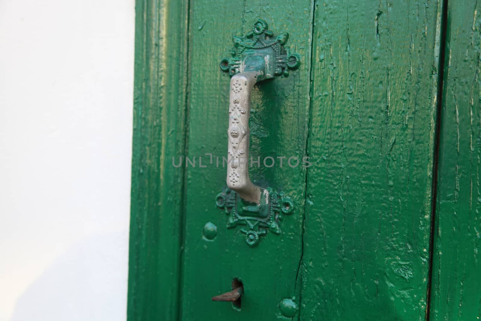 Green door with key and door handle
