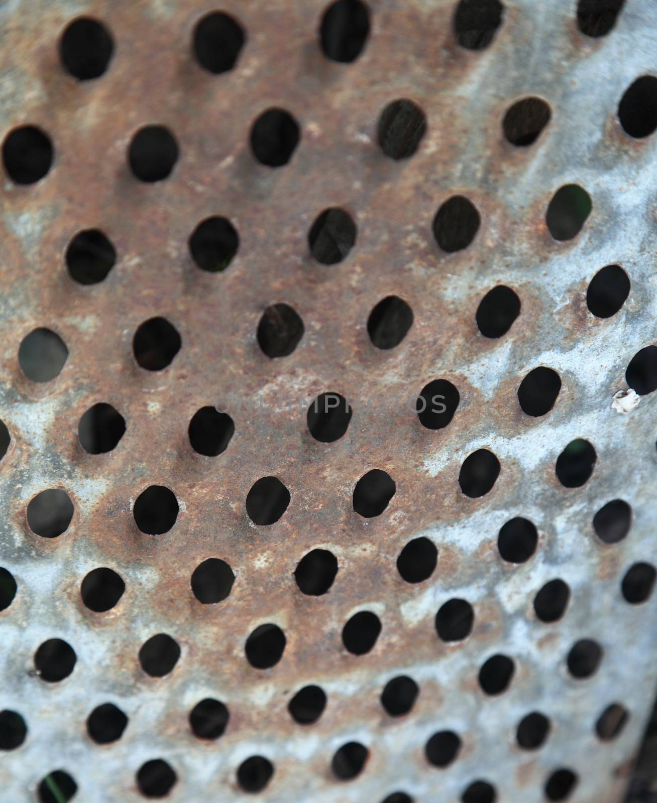 on the background of the old grater. Rusty metal