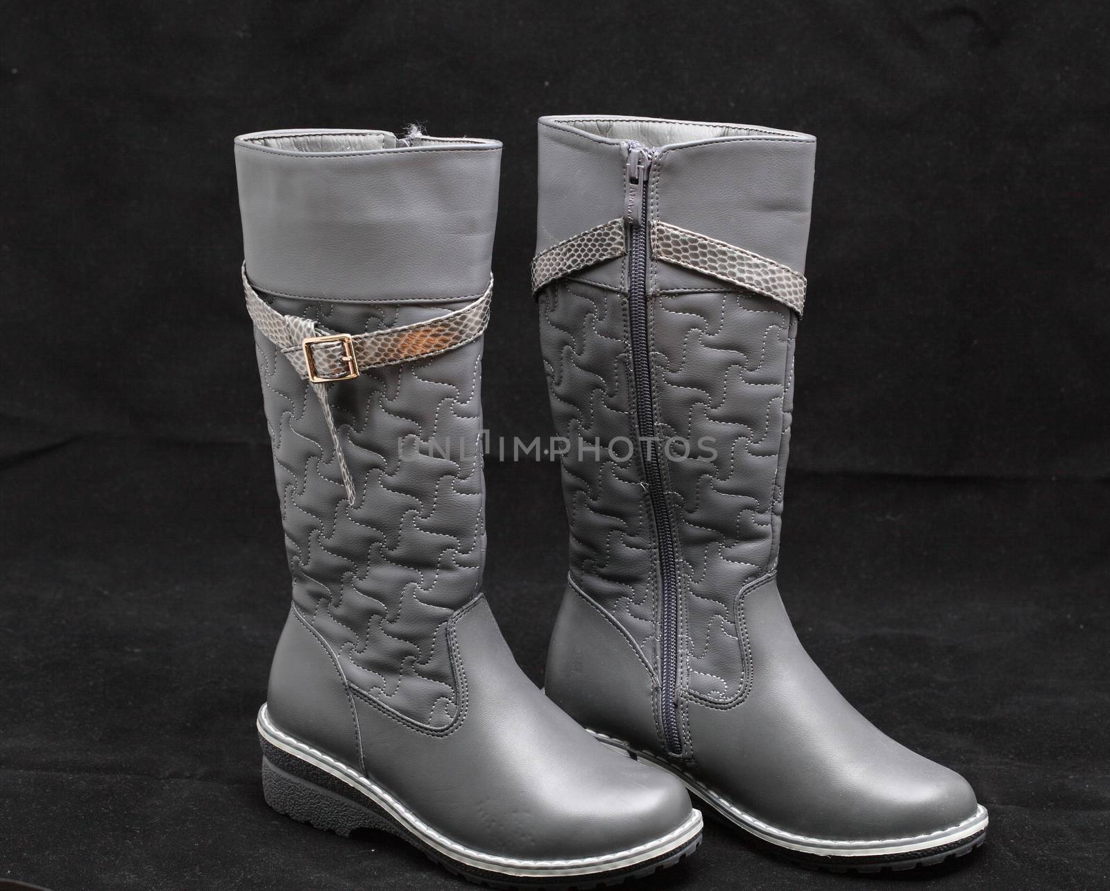 gray women's boots on black background