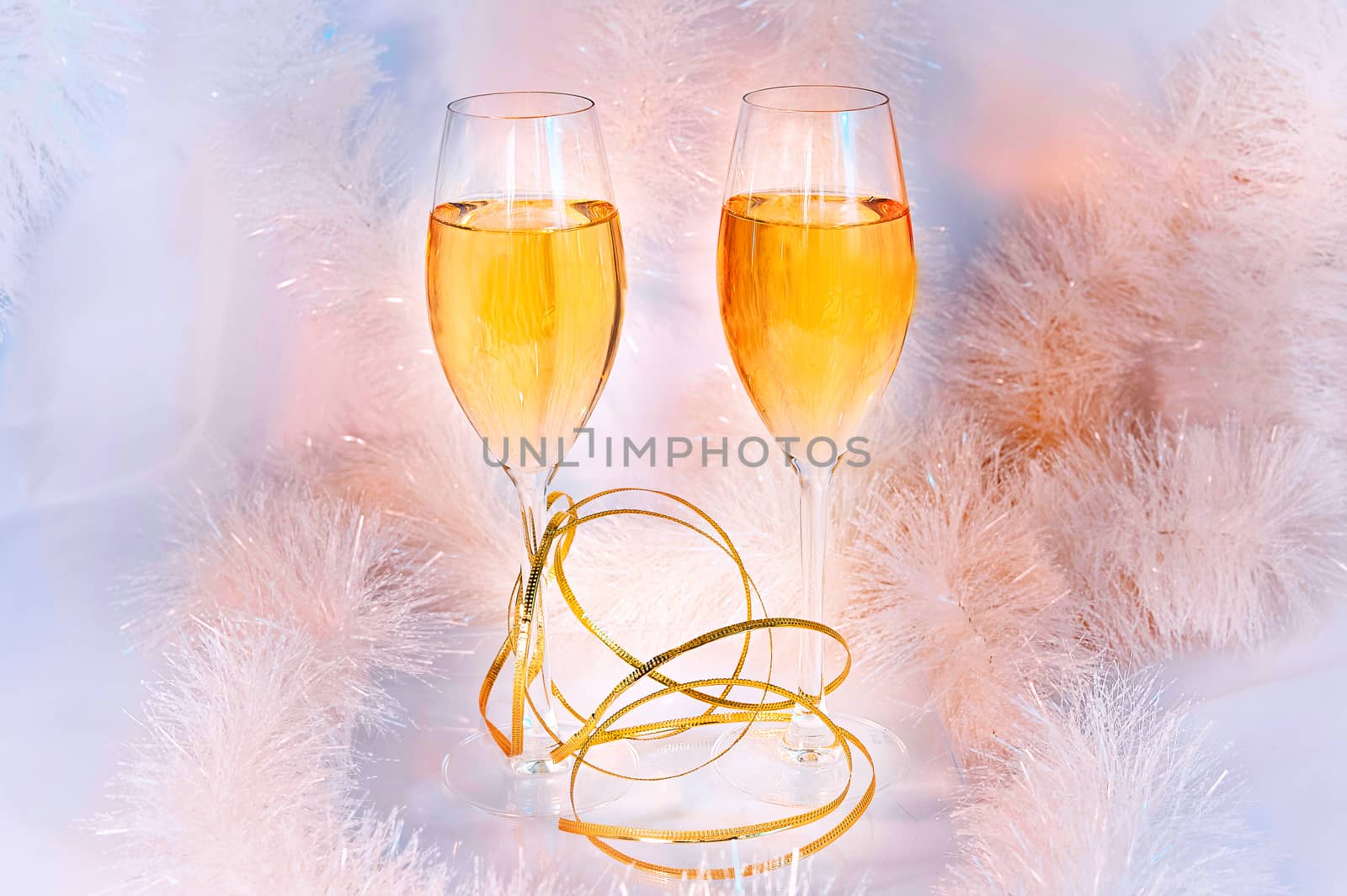 Two glasses of wine and tinsel. Holiday concept