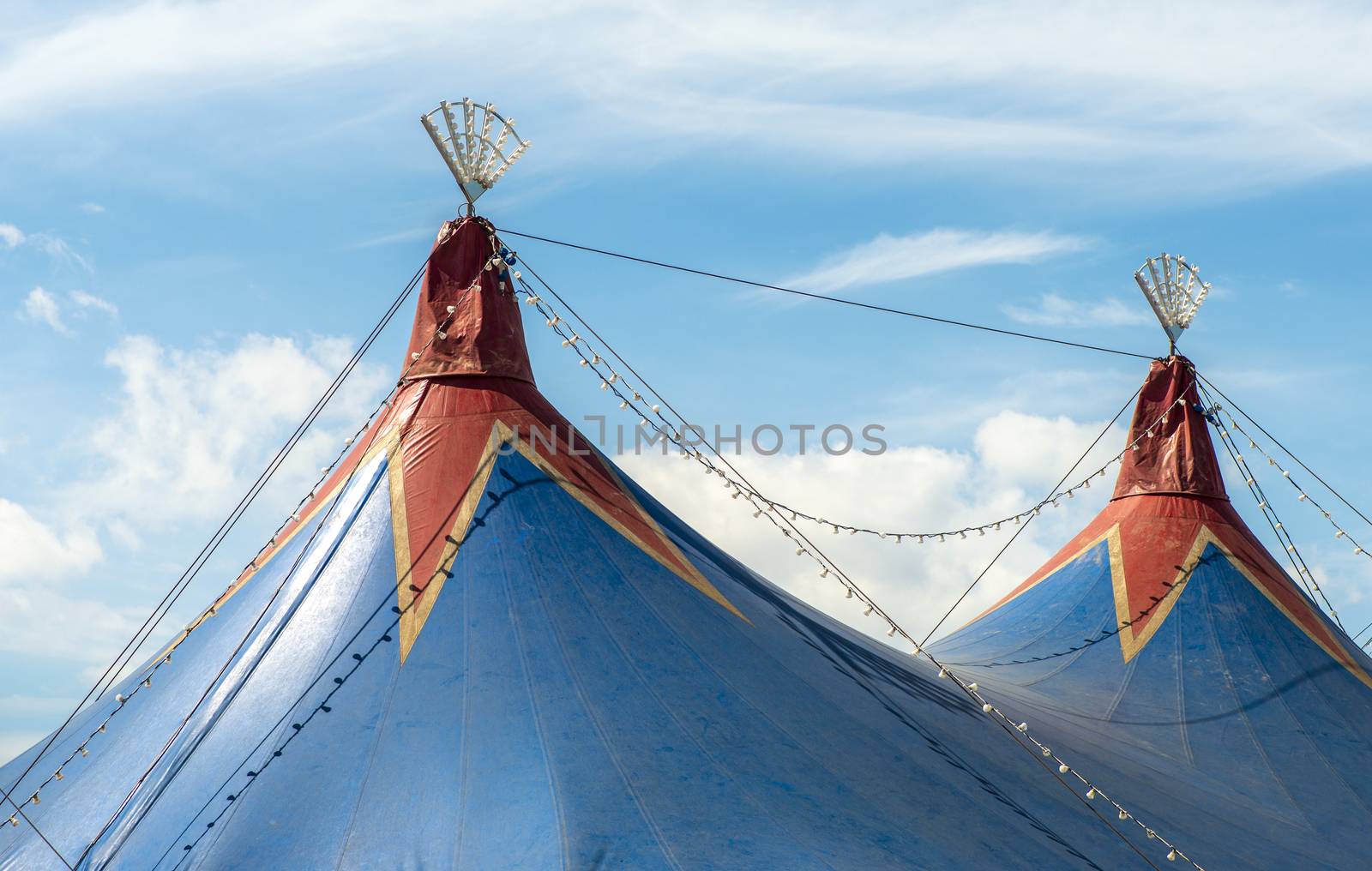 Blue dome of the circus and blue sky. Entertainment concept.