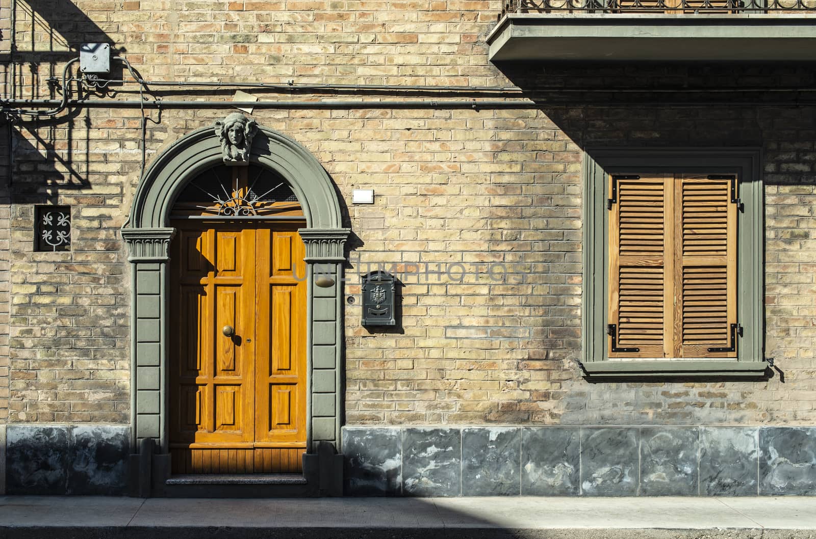 Old typical italian wooden door. Round door arch.  by deyan_georgiev