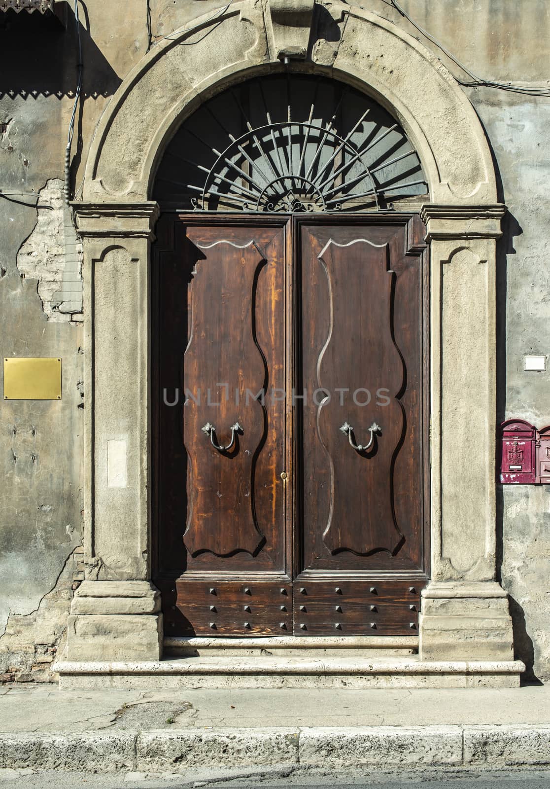 Old typical italian wooden door. Round door arch.  by deyan_georgiev