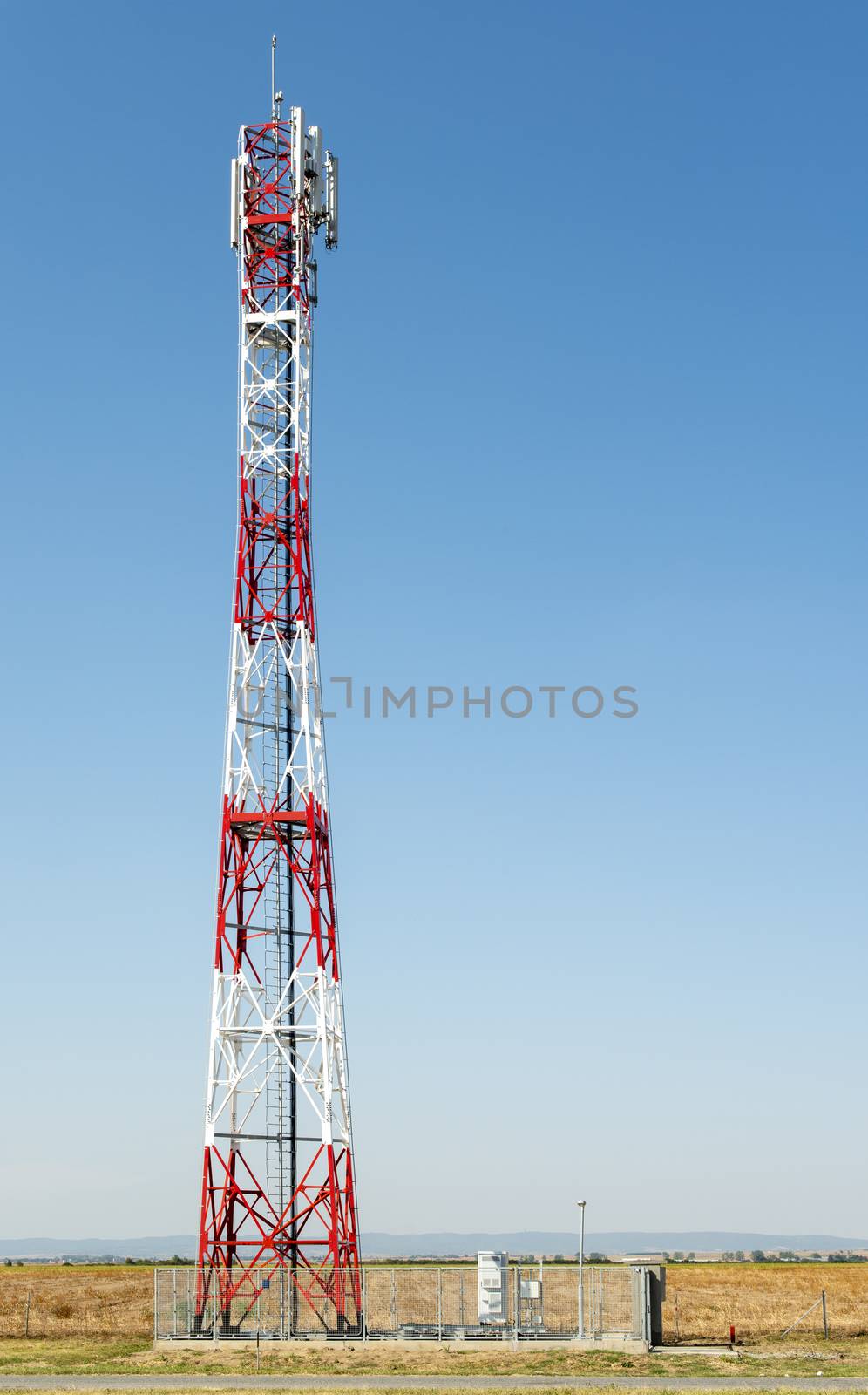 5G antenna for high speed internet distribution. 5G repeaters outside the city. Bright colours red and white.