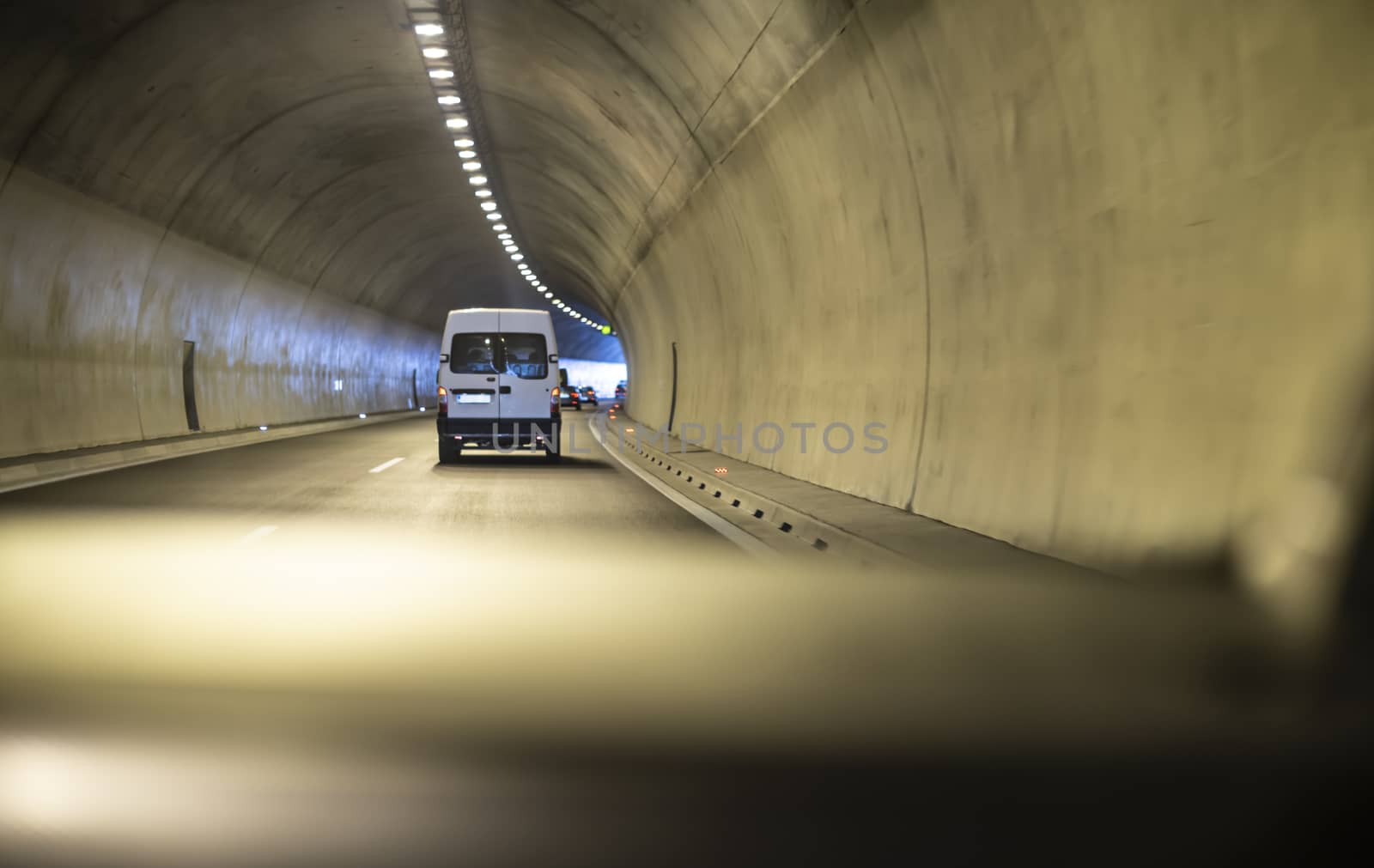 Bus traveling in highway tunnel.  by deyan_georgiev