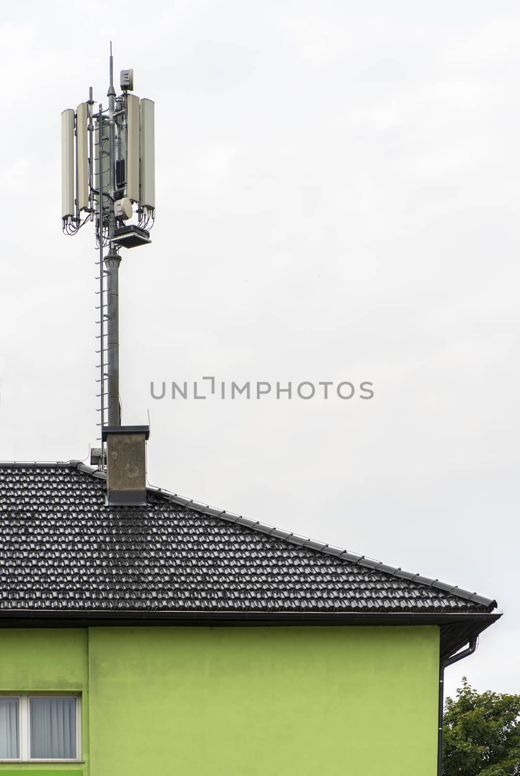5G antennas on top of house. Antennas and transmitters on roof. High speed mobile internet concept.
