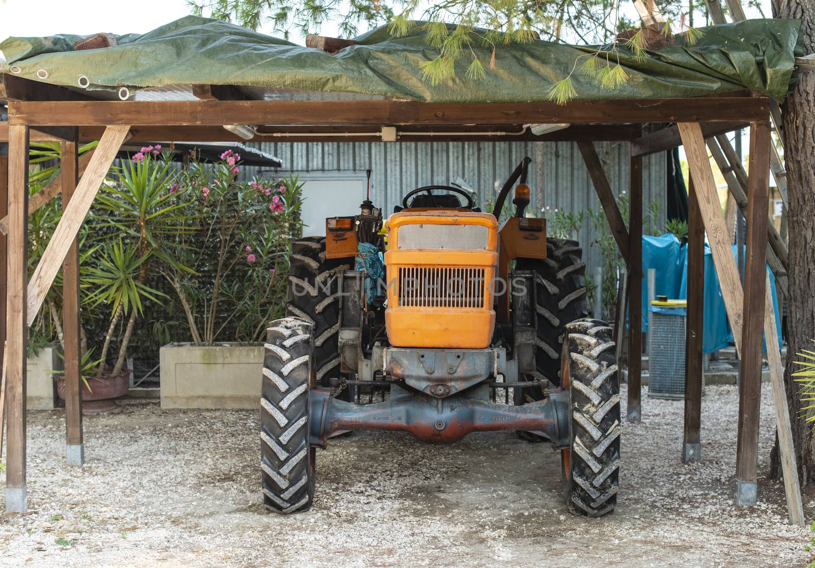 Farm tractor parked in the garage. Vintage tractor