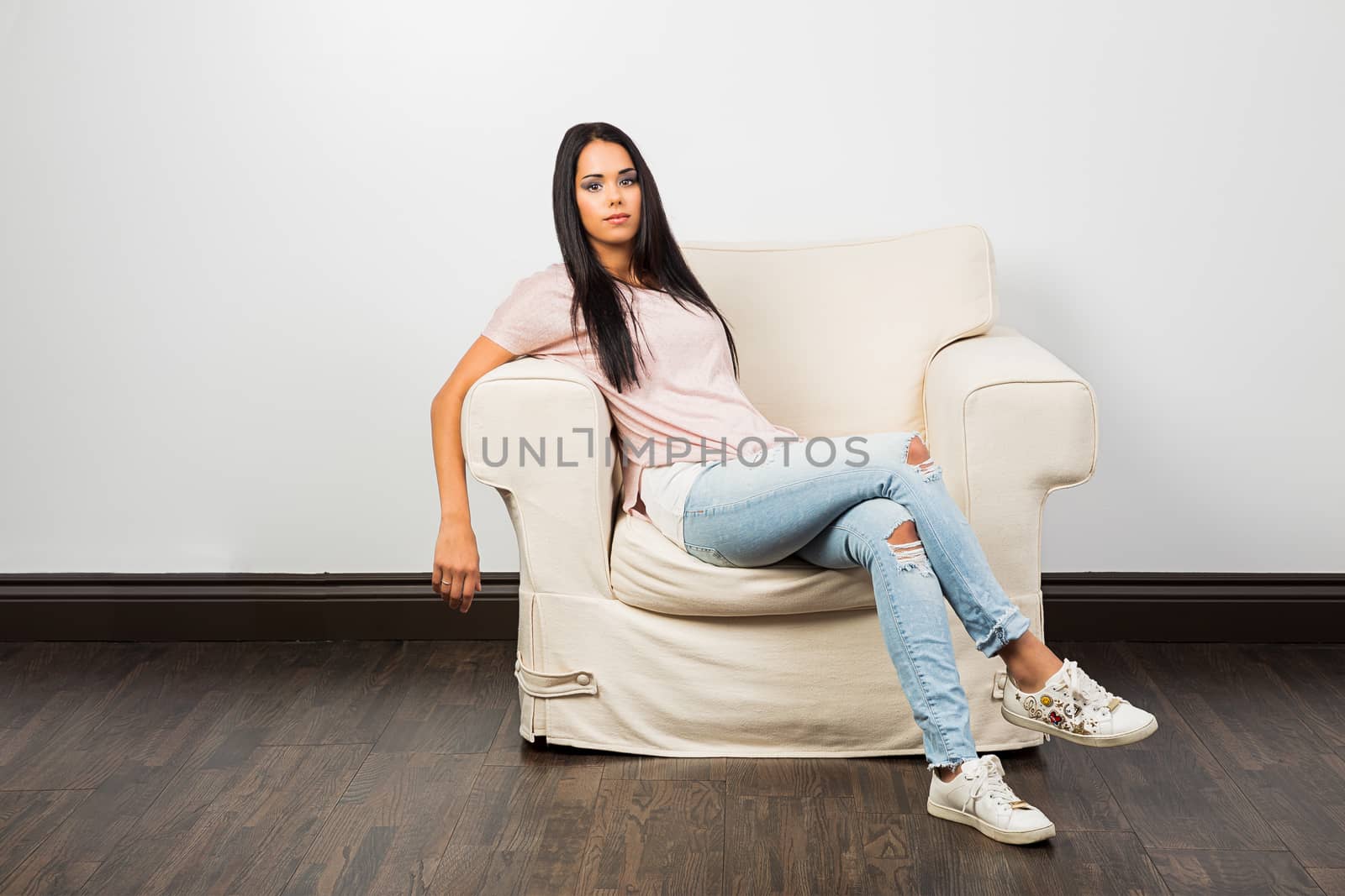 young woman relaxing on a one seat couch