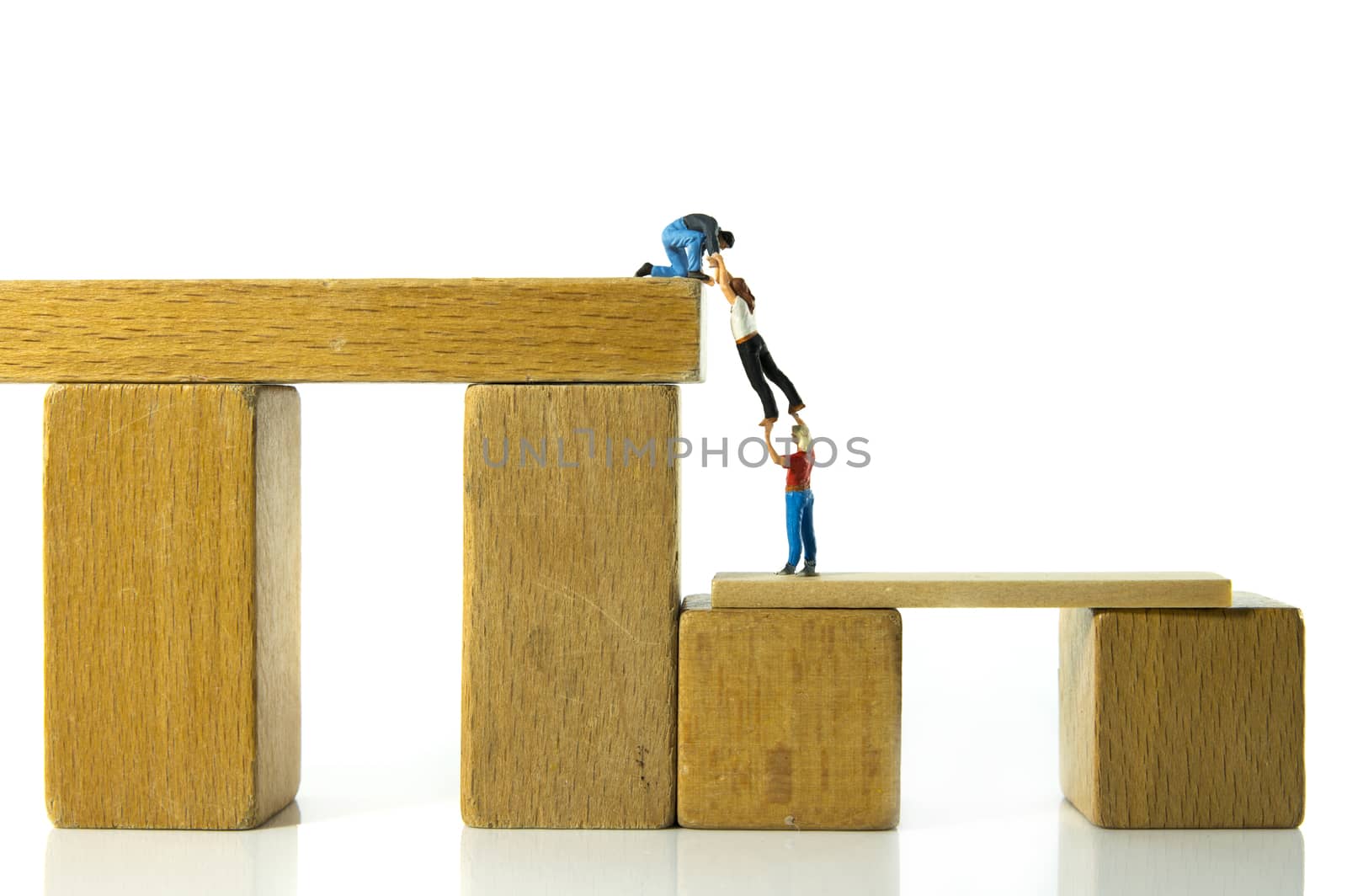 minitature figures man helping woman climbing up and coming higher