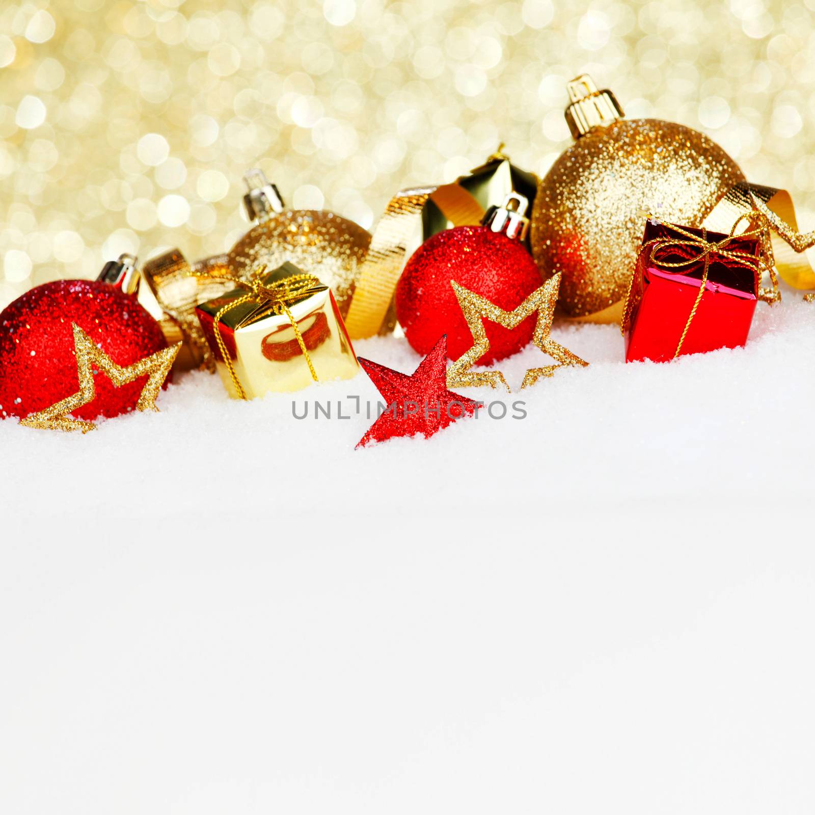 Red and golden christmas balls and decoration on snow