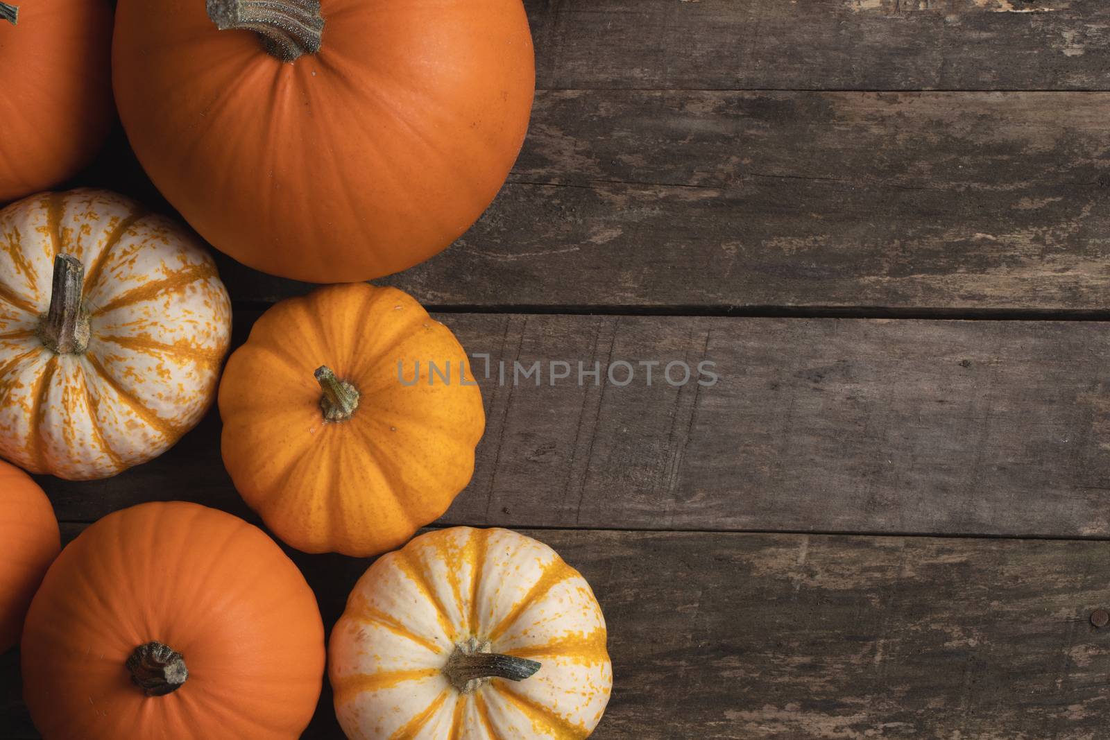 Many orange pumpkins on wooden background , Halloween concept , top view with copy space