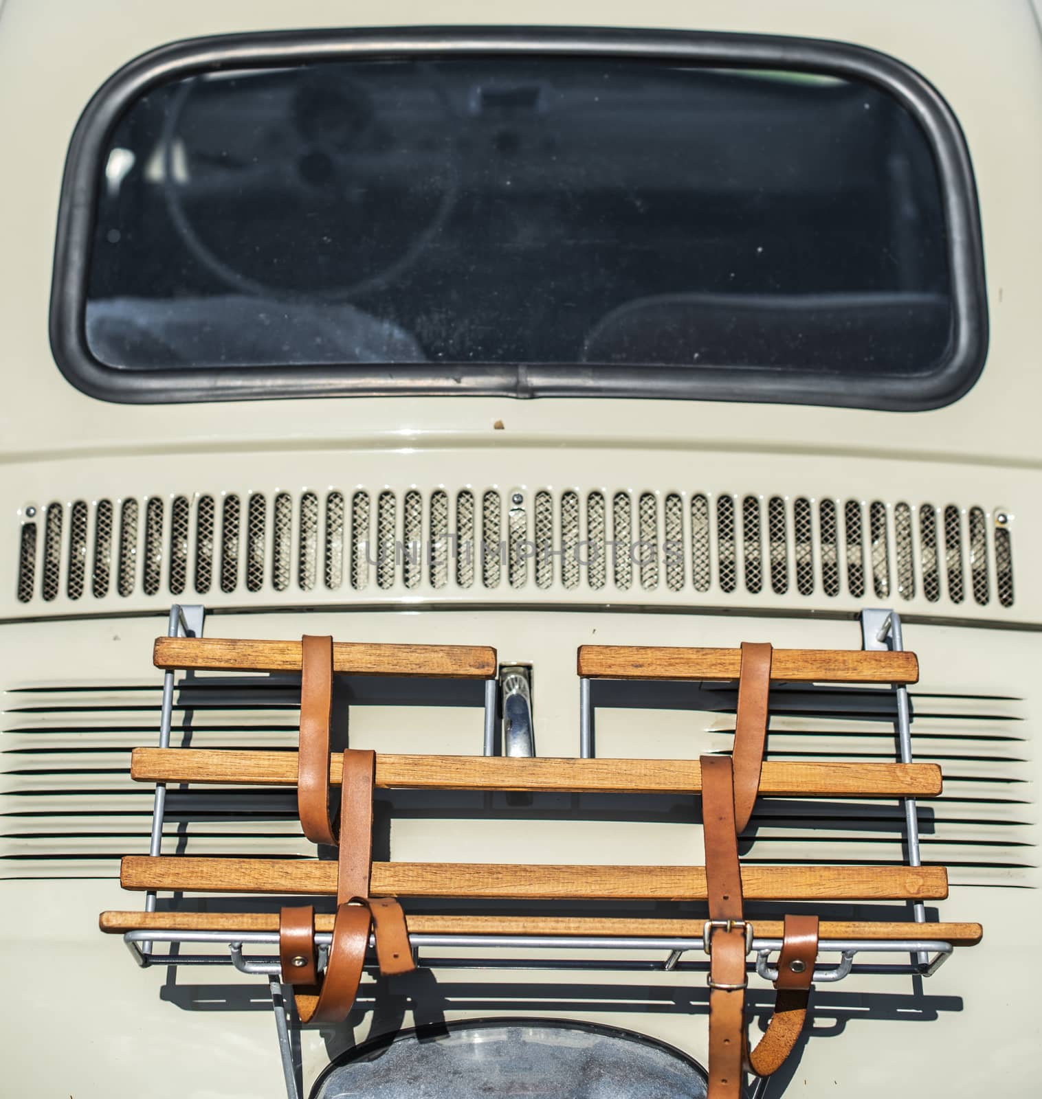 Vintage beige color car trunk. Small old car. Italian car. Sunny day