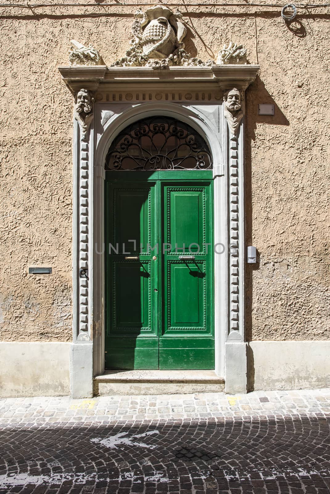 Typical italian facade with door.  Italian house. Traditional style and ornaments. 