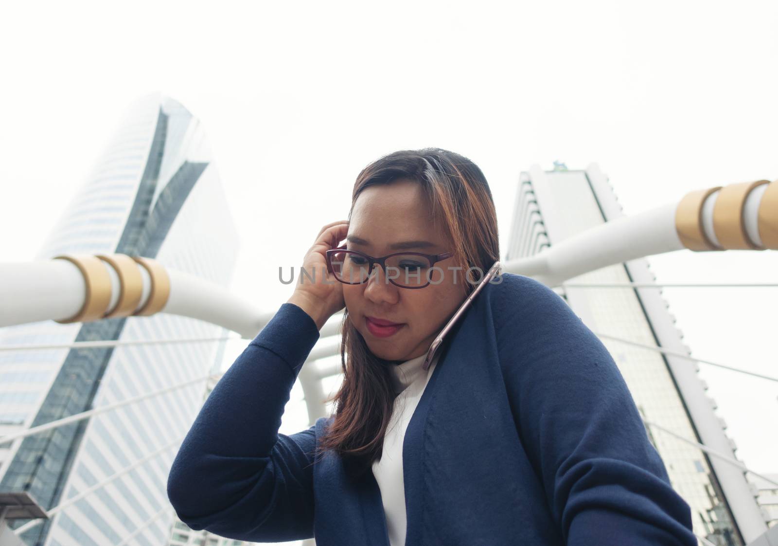 businesswoman walking outdoor and talking on mobile phone