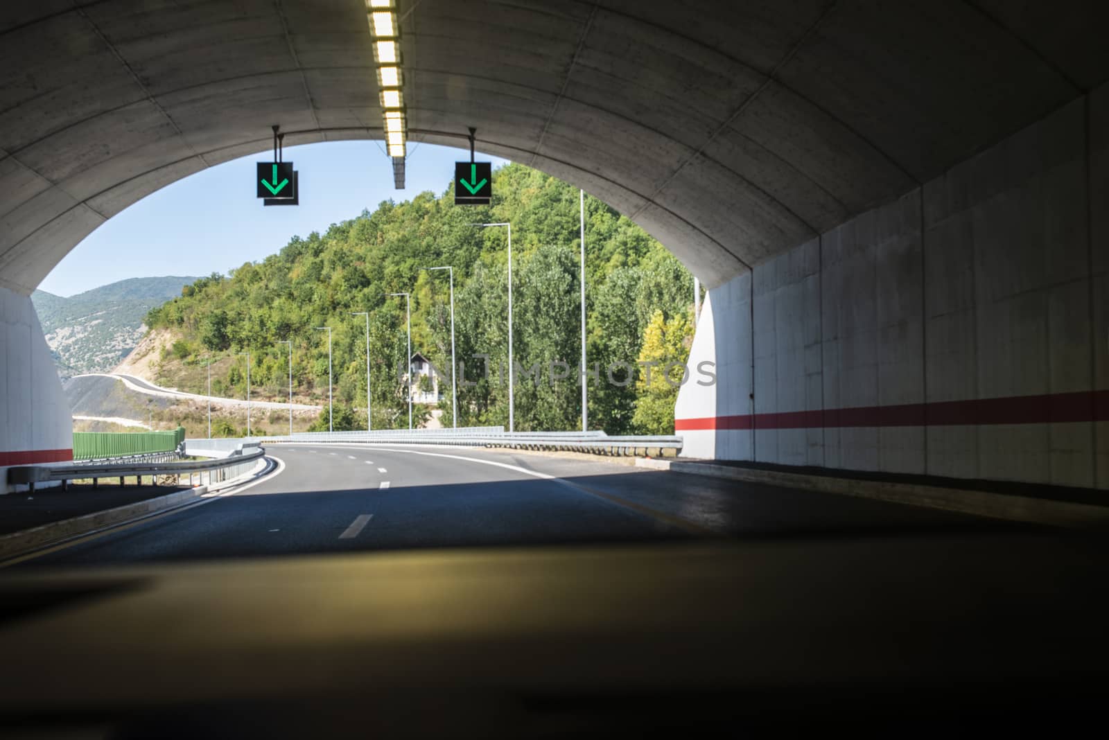 Highway tunnel. Signs in tunnel. Mountain road. Travel and traff by deyan_georgiev