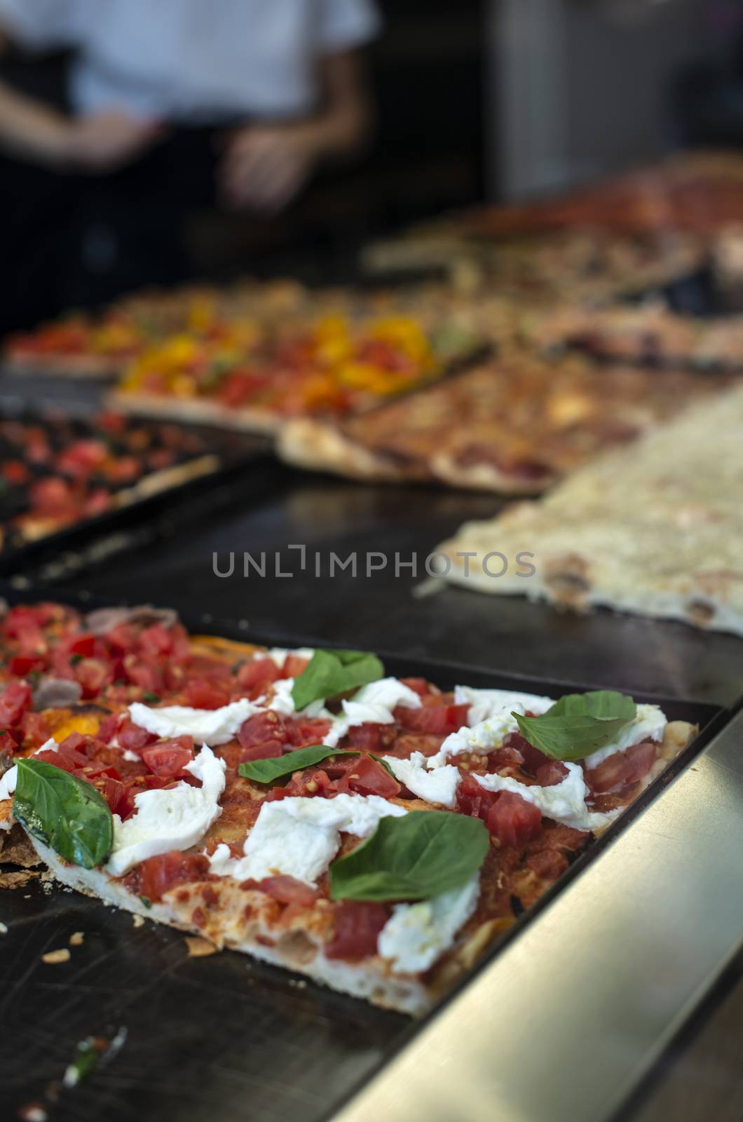 Italian street pizza shop. Pizzas on showcase. by deyan_georgiev