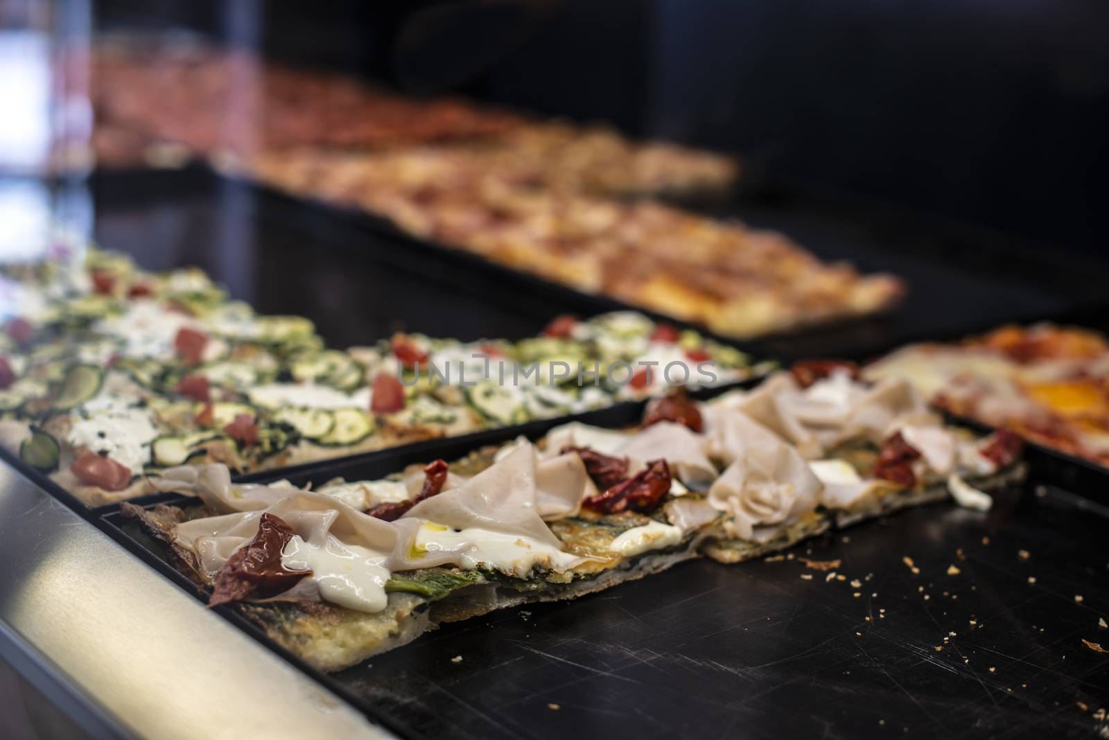 Italian street pizza shop. Pizzas on showcase.