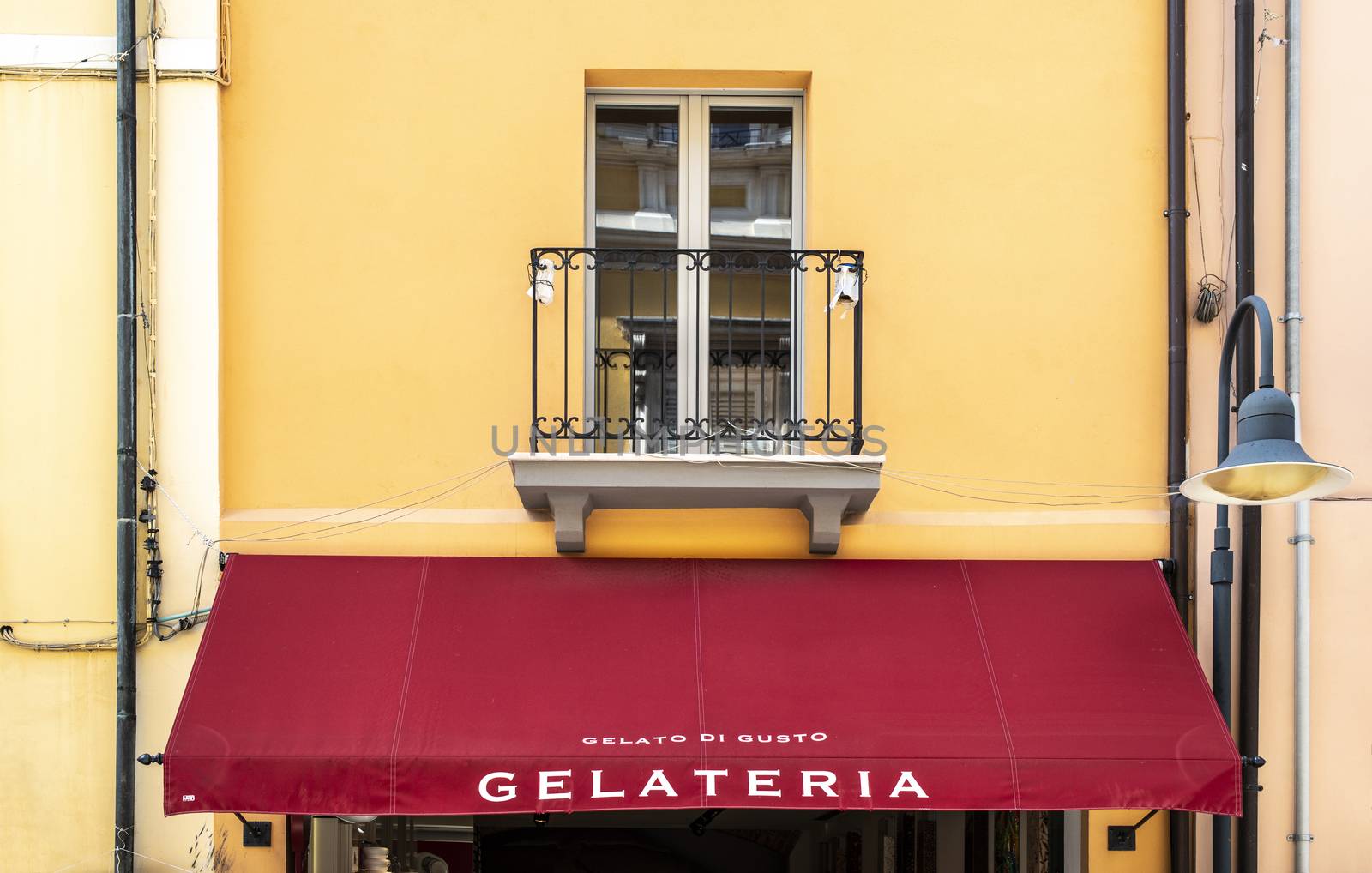 Italian ice cream shop. Text gelateria on sunshade. Italian architecture.