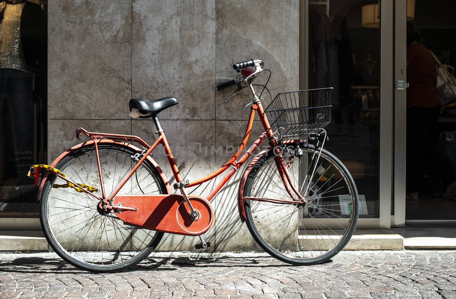 Red bike with basket on italian street. Typical italian architec by deyan_georgiev