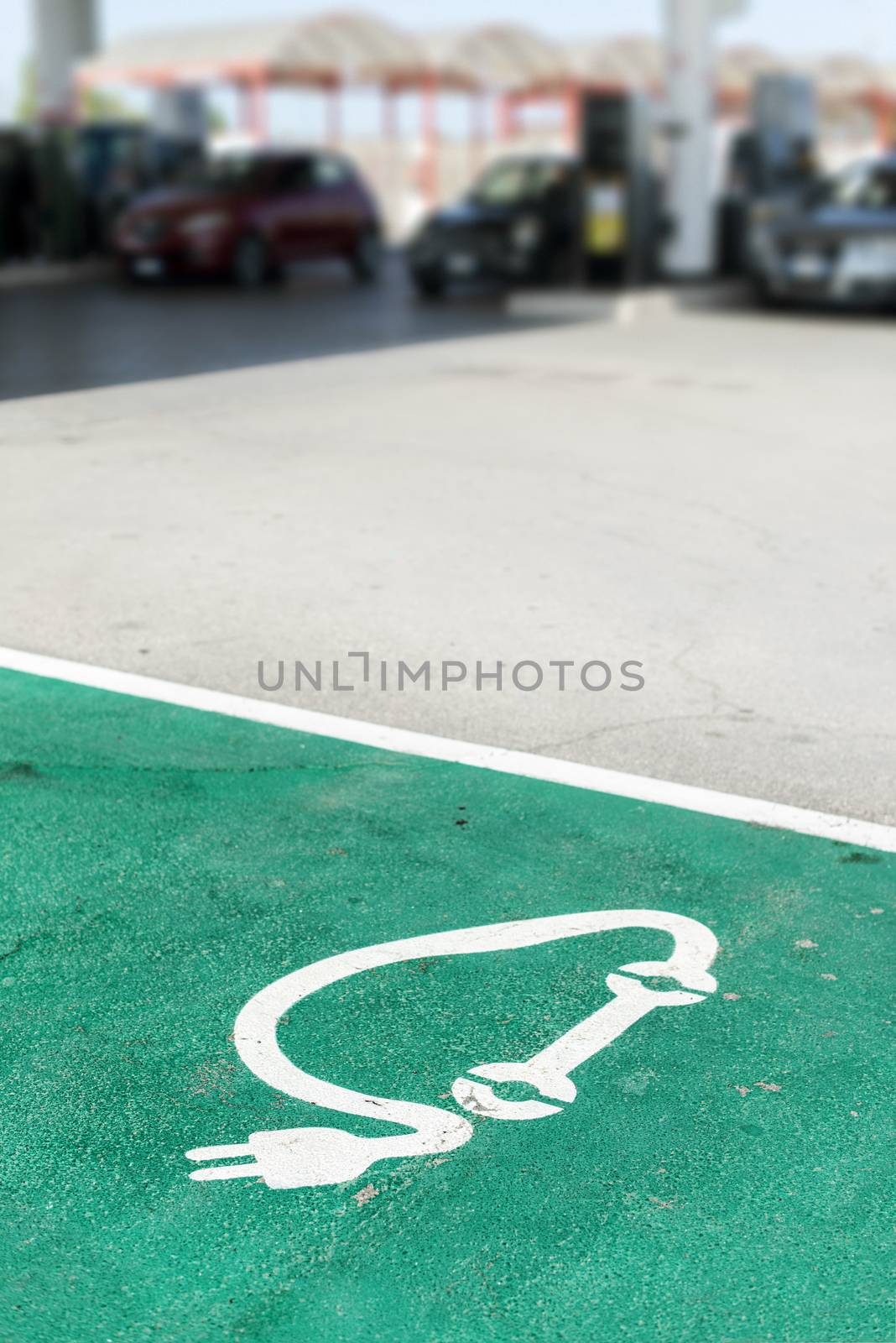 Car charging symbol painted on asphalt.  by deyan_georgiev