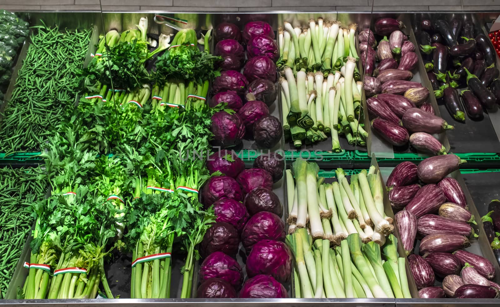 Vegetables on shelf in supermarket.  by deyan_georgiev