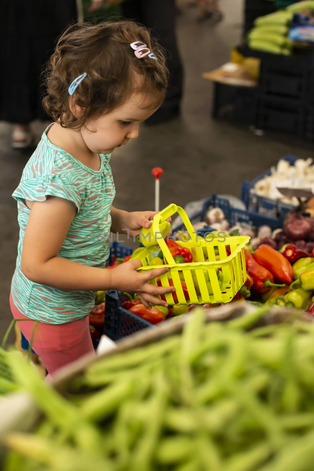Kid shopping in vegetable market.  by deyan_georgiev