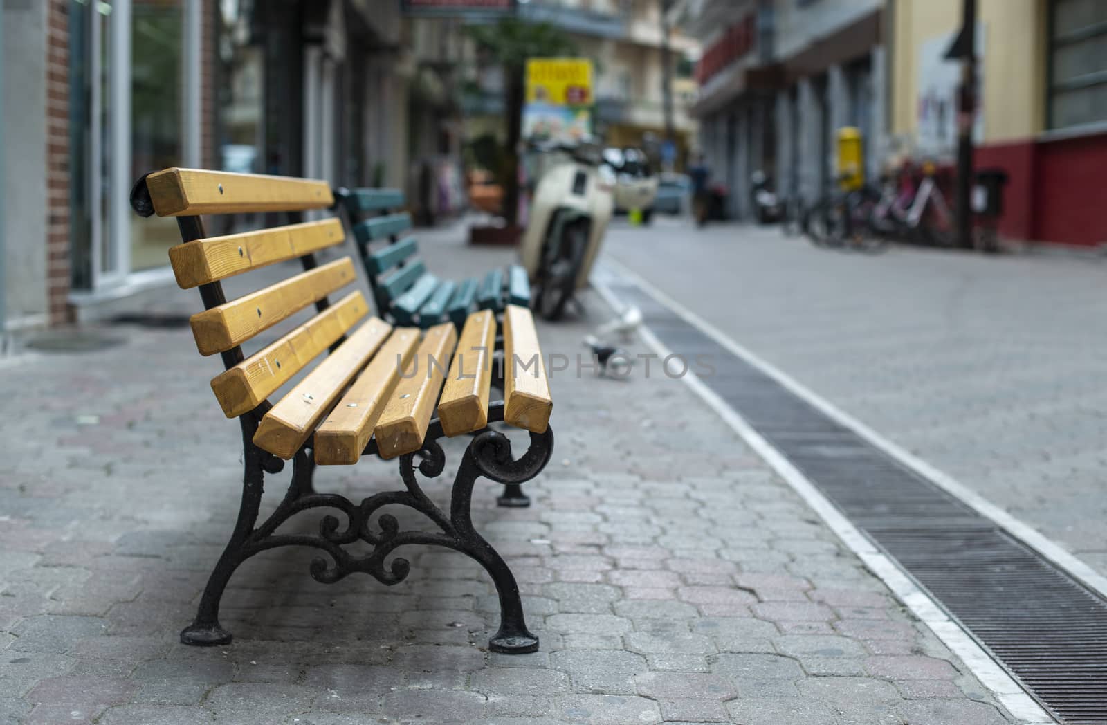 Wooden Bench on the street. No people. Shopping street