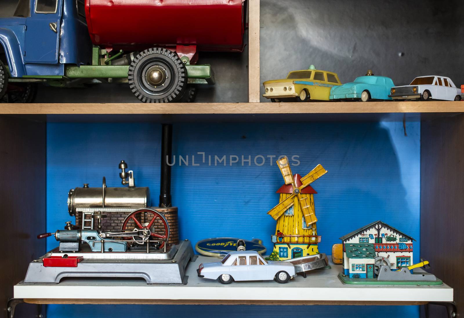 Old vintage toys on shelf. Collection of vintage cars toys in a shop. Bright colours.