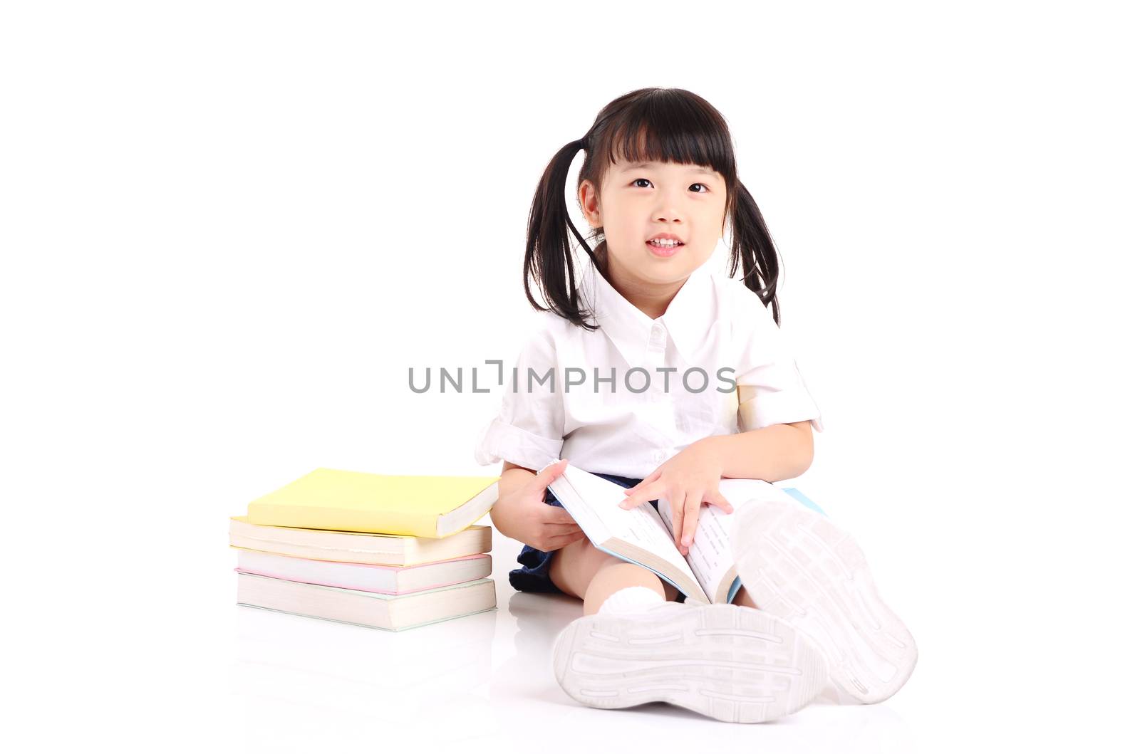 Asian girl sitting on the floor and reading book