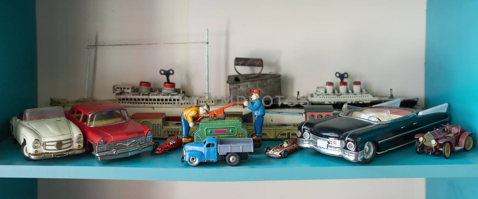 Old vintage toys on shelf. Collection of vintage cars toys in a shop. Bright colours.