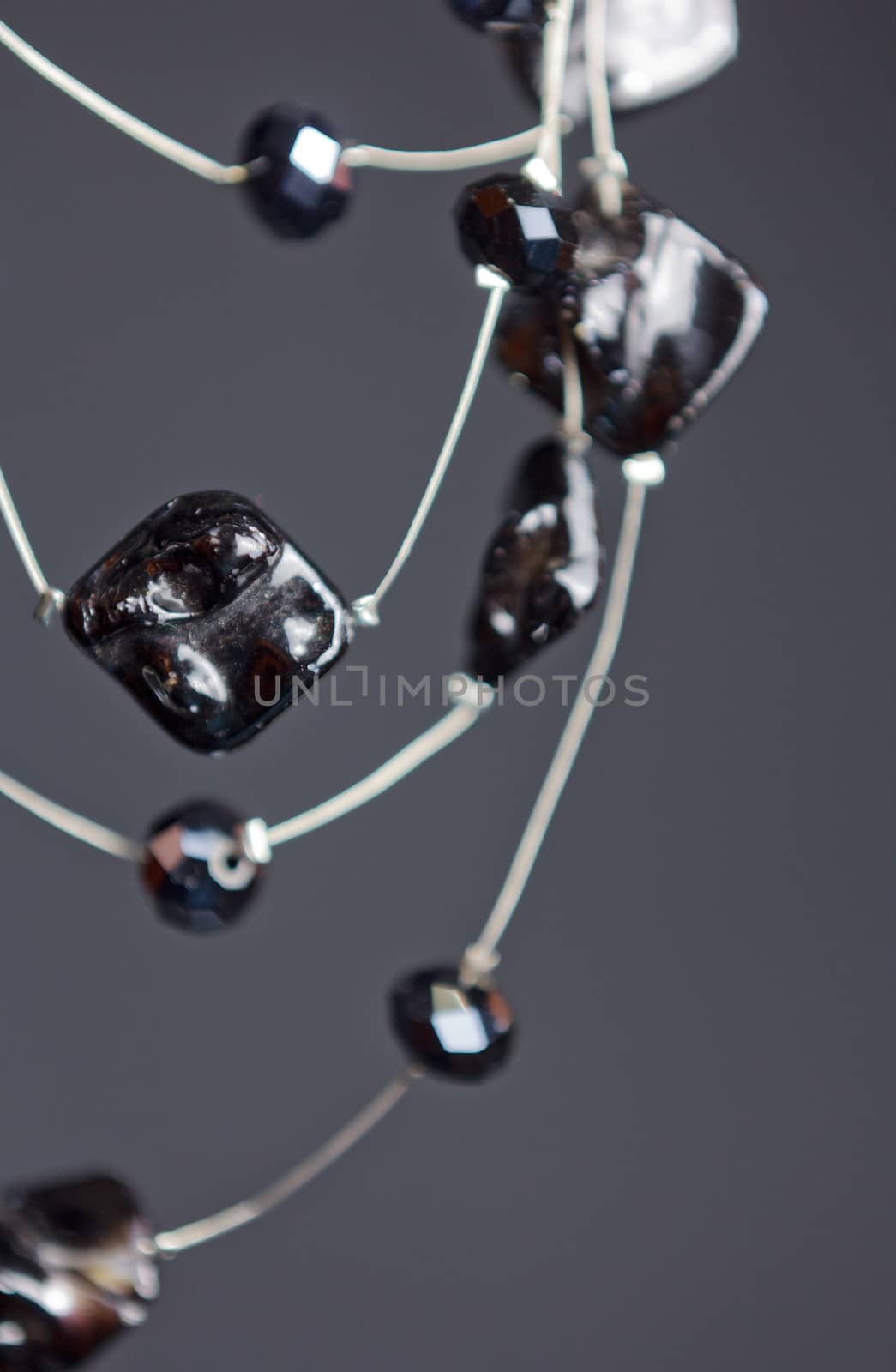 handmade jewelry made of beads in macro. necklaces from black beads. necklaces from stones by yulaphotographer