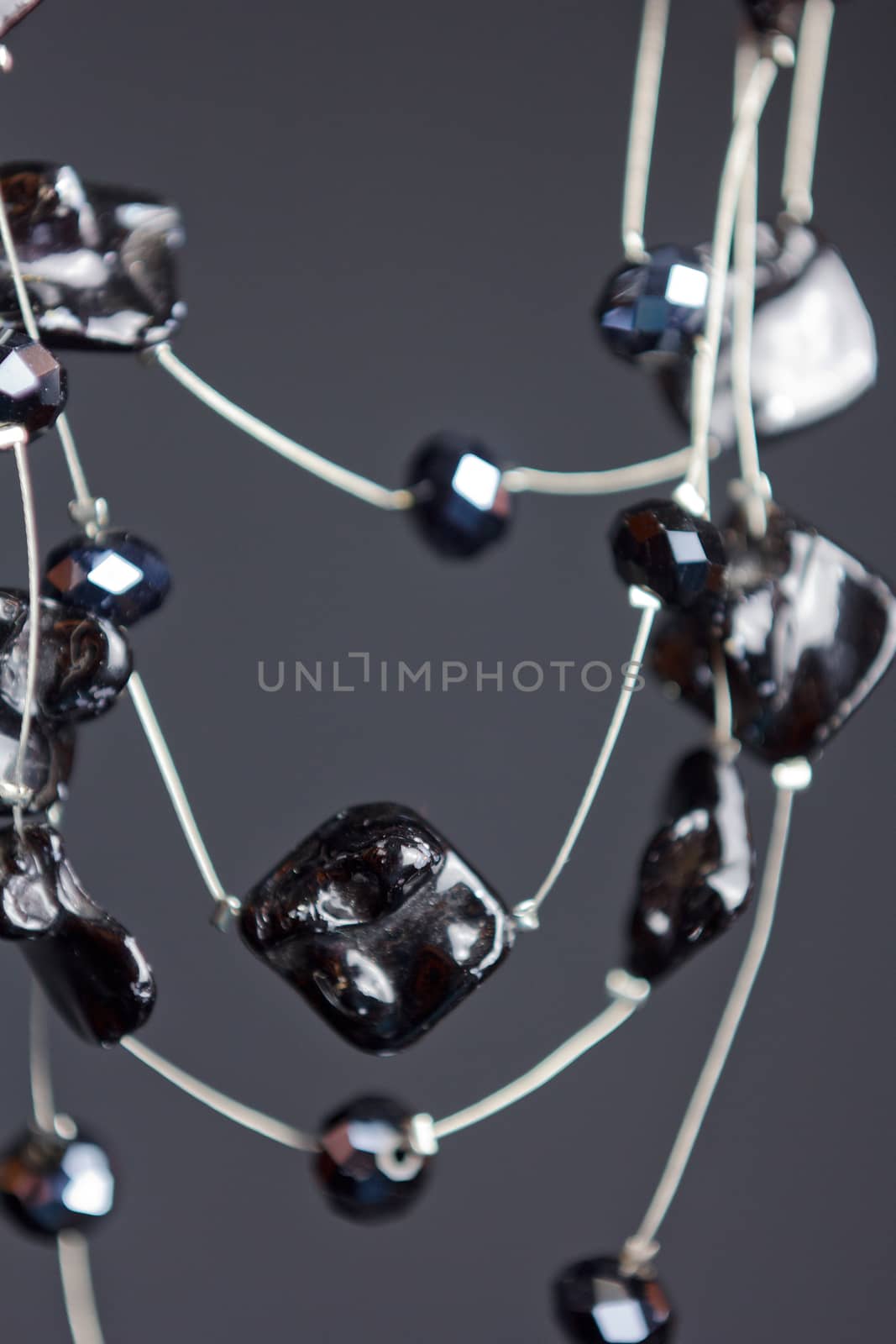 handmade jewelry made of beads in macro. necklaces from black beads. necklaces from stones by yulaphotographer