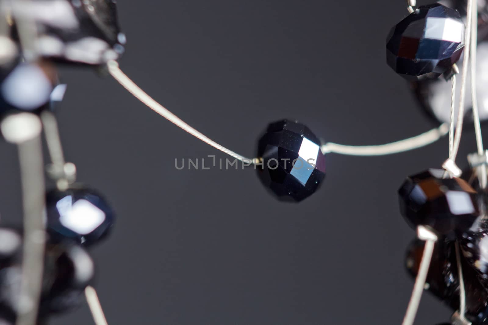 handmade jewelry made of beads in macro. necklaces from black beads. necklaces from stones by yulaphotographer