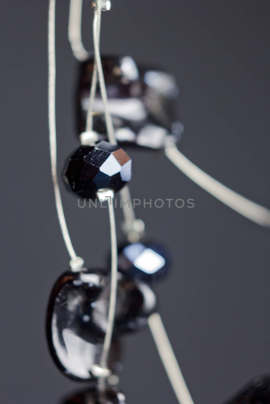 handmade jewelry made of beads in macro. necklaces from black beads. necklaces from stones by yulaphotographer