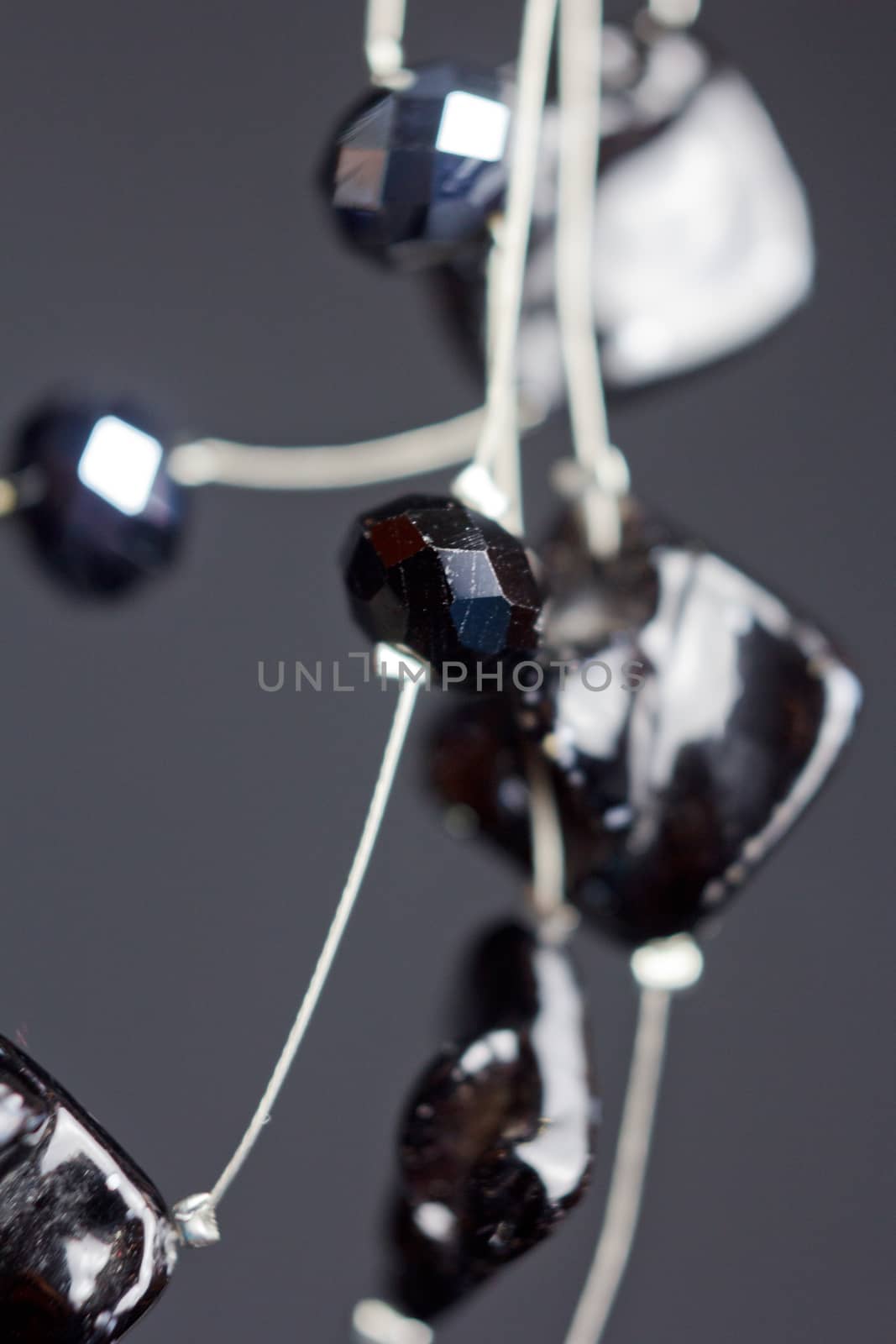 handmade jewelry made of beads in macro. necklaces from black beads. necklaces from stones. beautiful ornaments. necklaces from black beads. ornaments on a black background