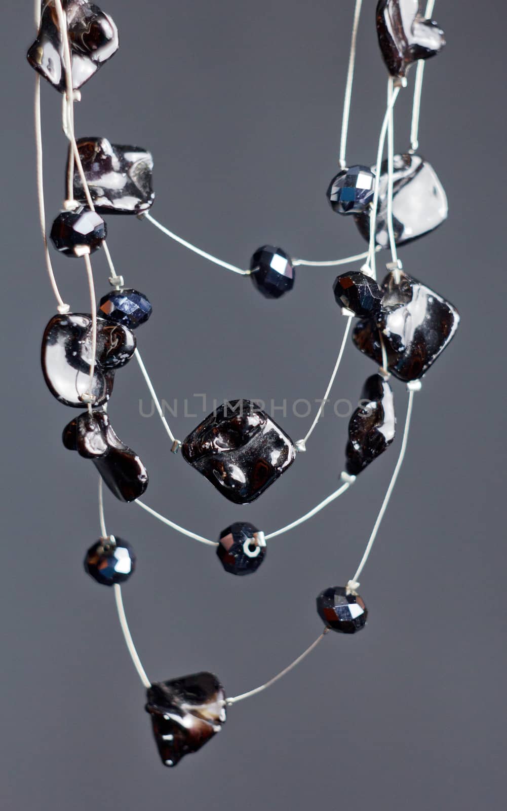 handmade jewelry made of beads in macro. necklaces from black beads. necklaces from stones by yulaphotographer