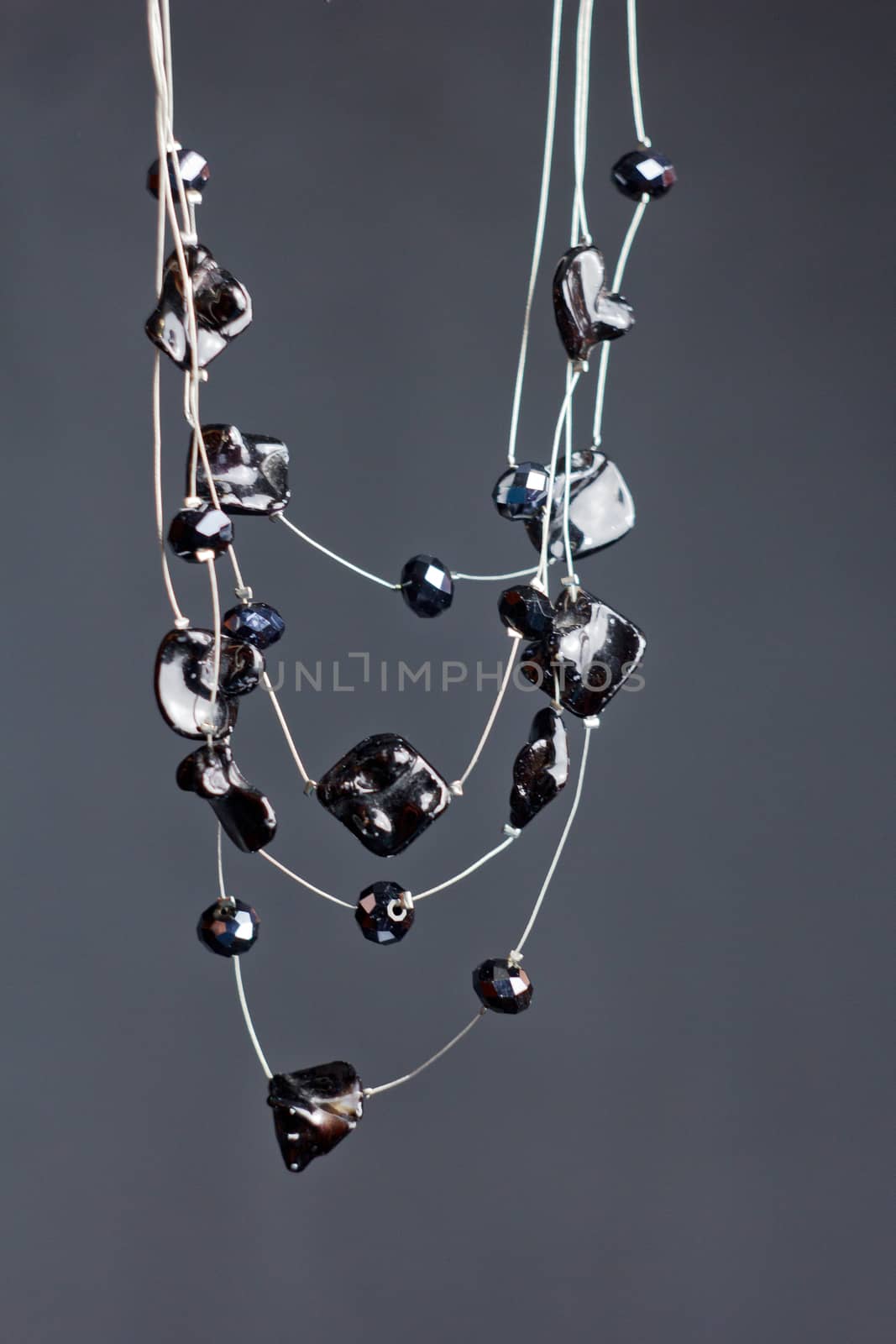 handmade jewelry made of beads in macro. necklaces from black beads. necklaces from stones by yulaphotographer