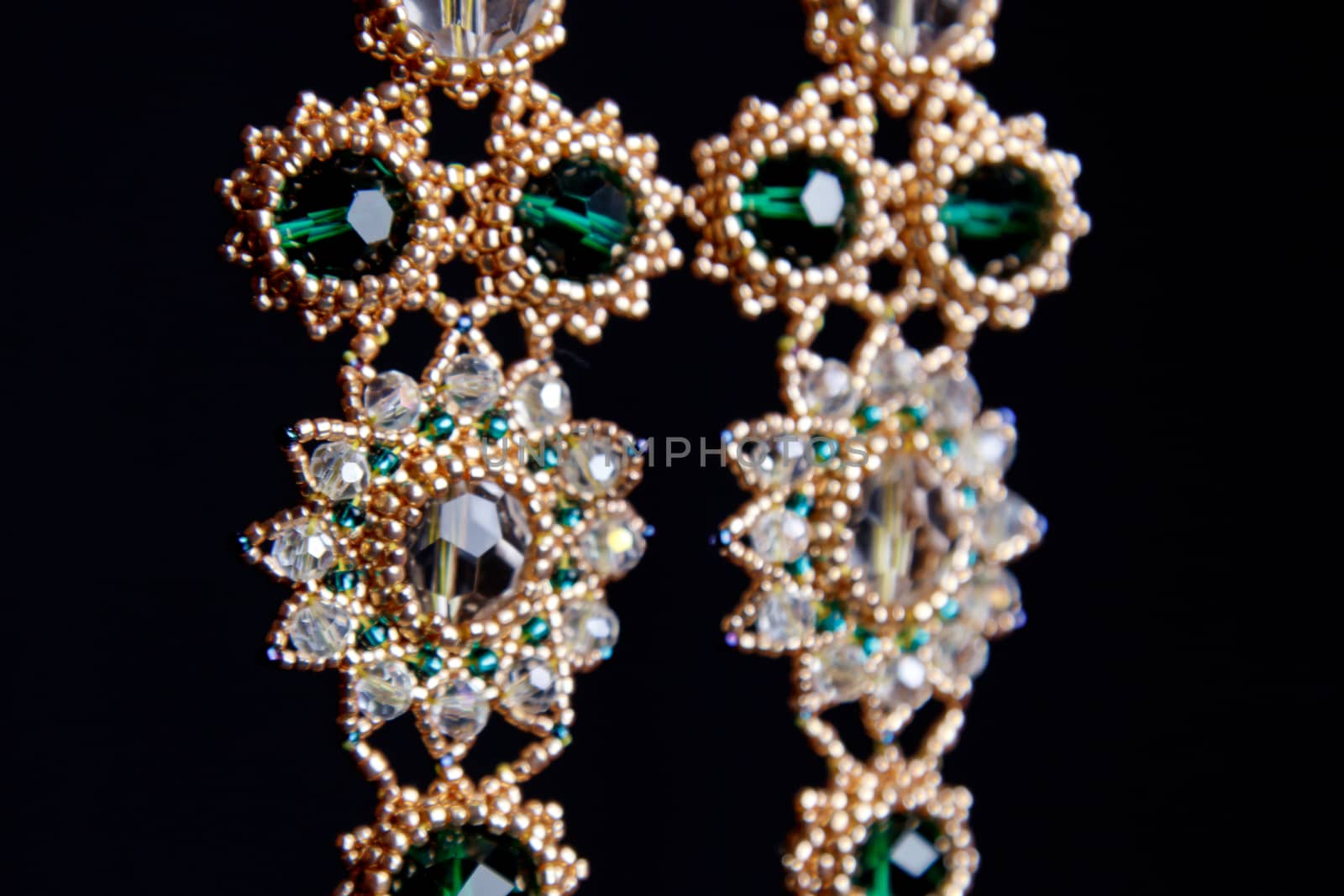 handmade jewelry made of beads in macro. earrings from white beads. earrings from stones by yulaphotographer