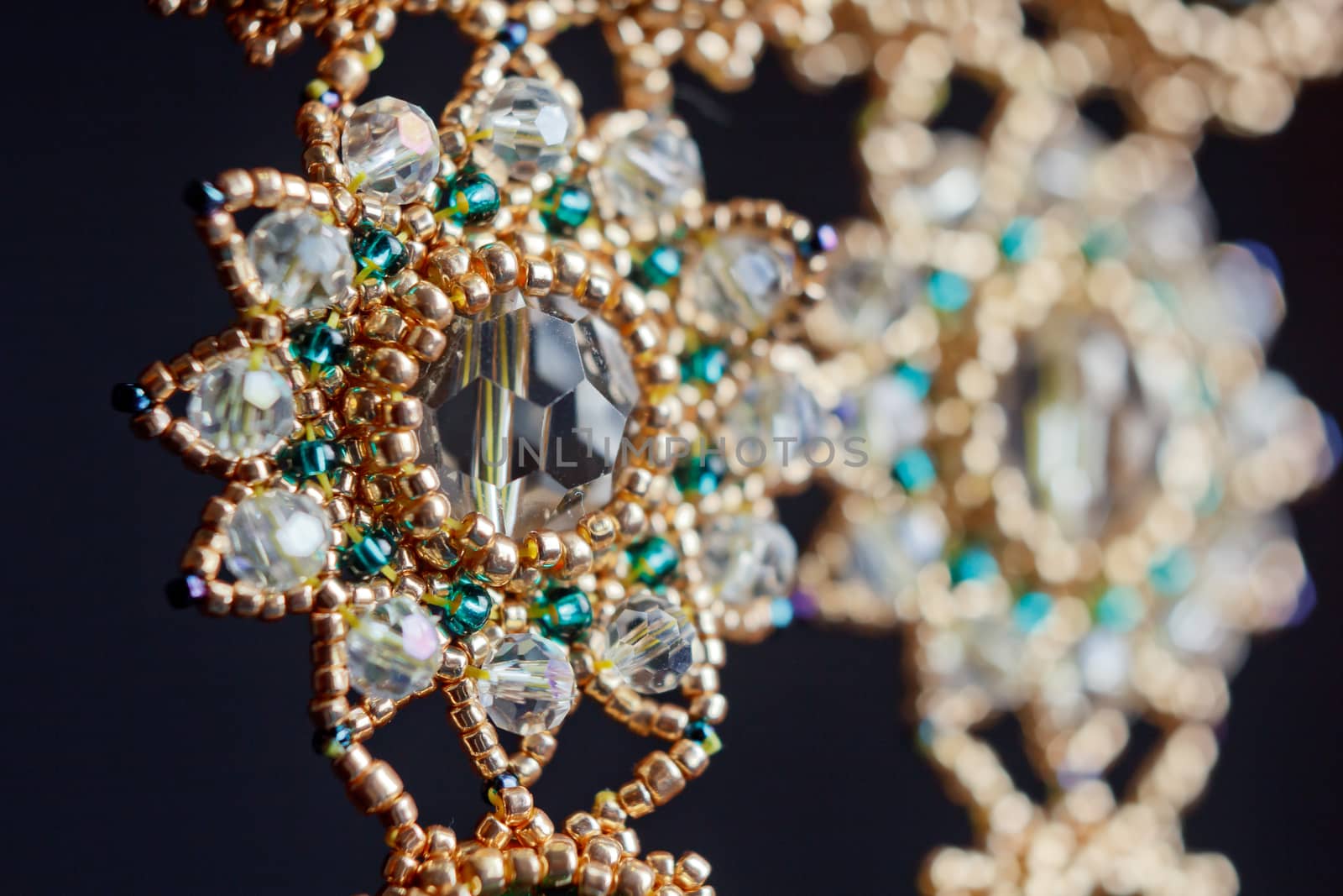 handmade jewelry made of beads in macro. earrings from white beads. earrings from stones by yulaphotographer