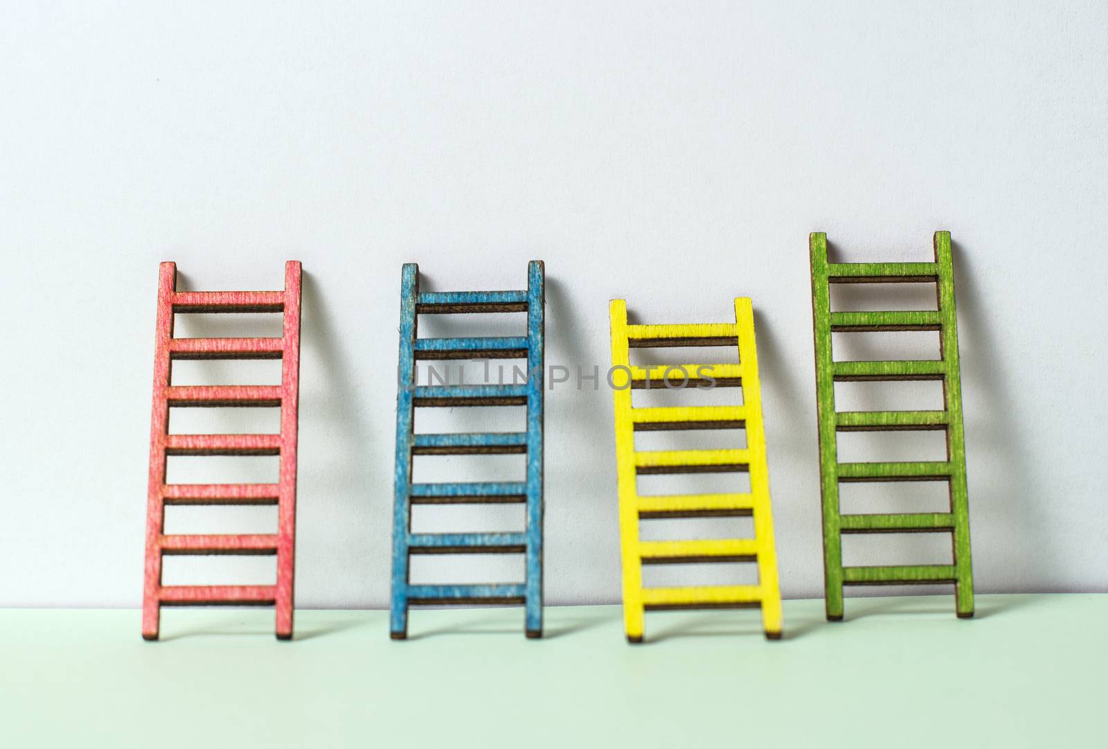 Multicoloured ladders on wall. Pastel tones. Concept for success by deyan_georgiev